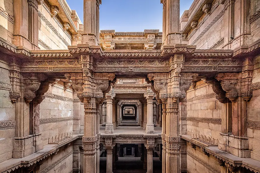 Carved stone galleries of a stepwell descending in symmetrical tiers