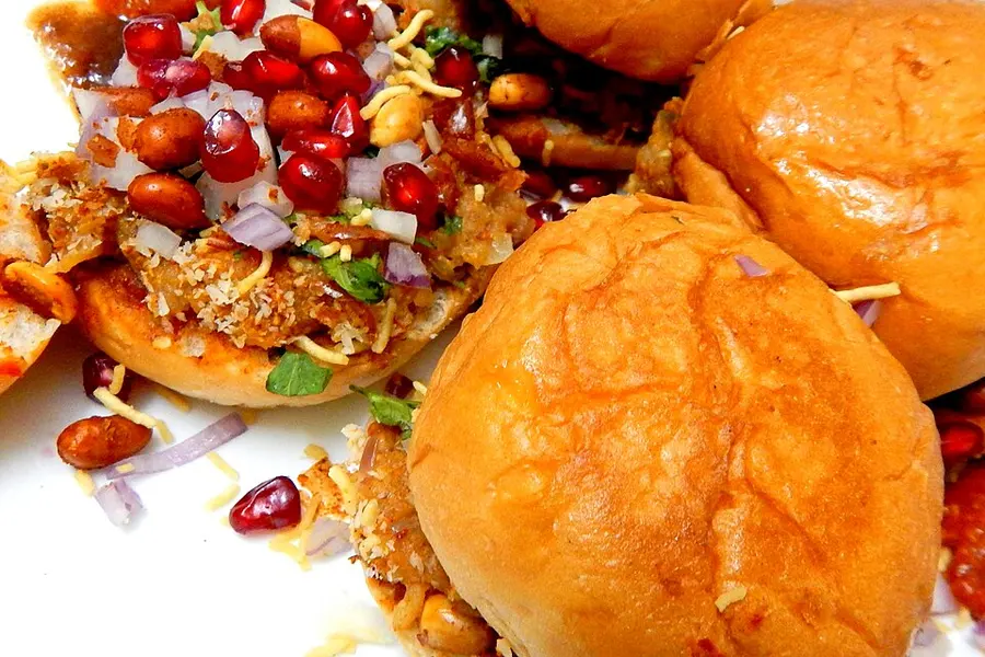 Dabeli buns loaded with filling, pomegranate seeds and sev