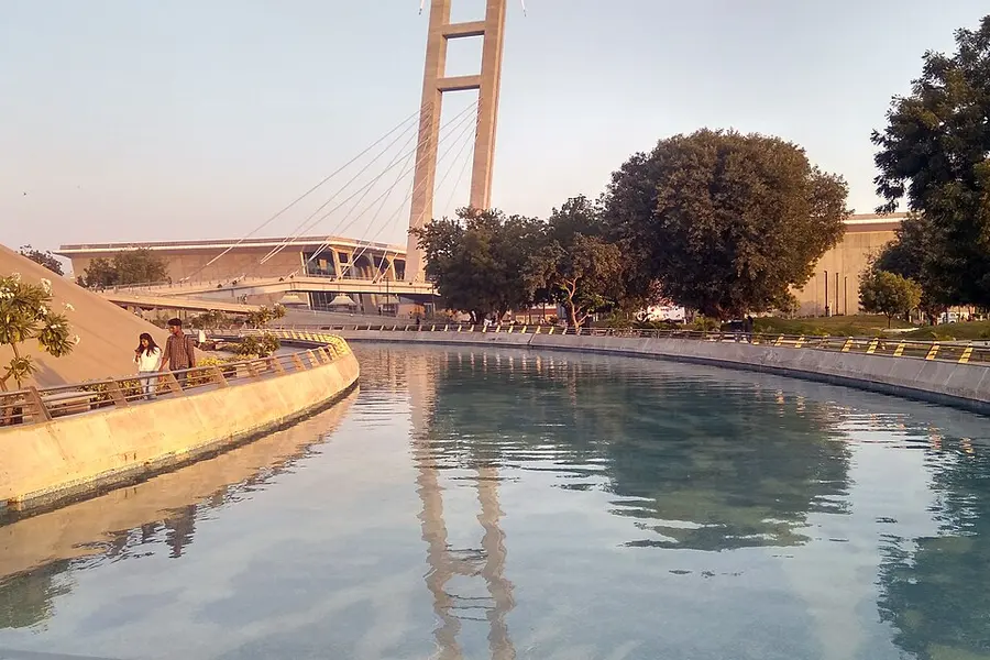 A curved water channel and landscaping in the Mahatma Mandir grounds