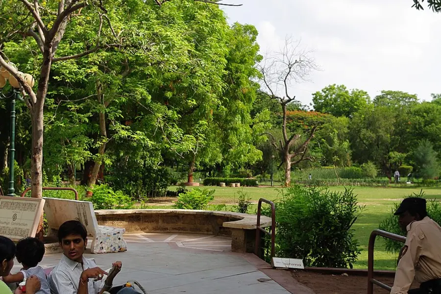 Trees, benches and lawn inside Law Garden during the day